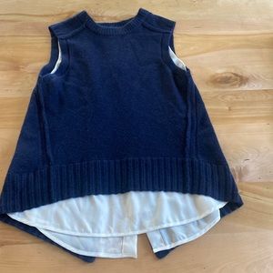 Women’s sleeveless sweater with silk blouse underneath